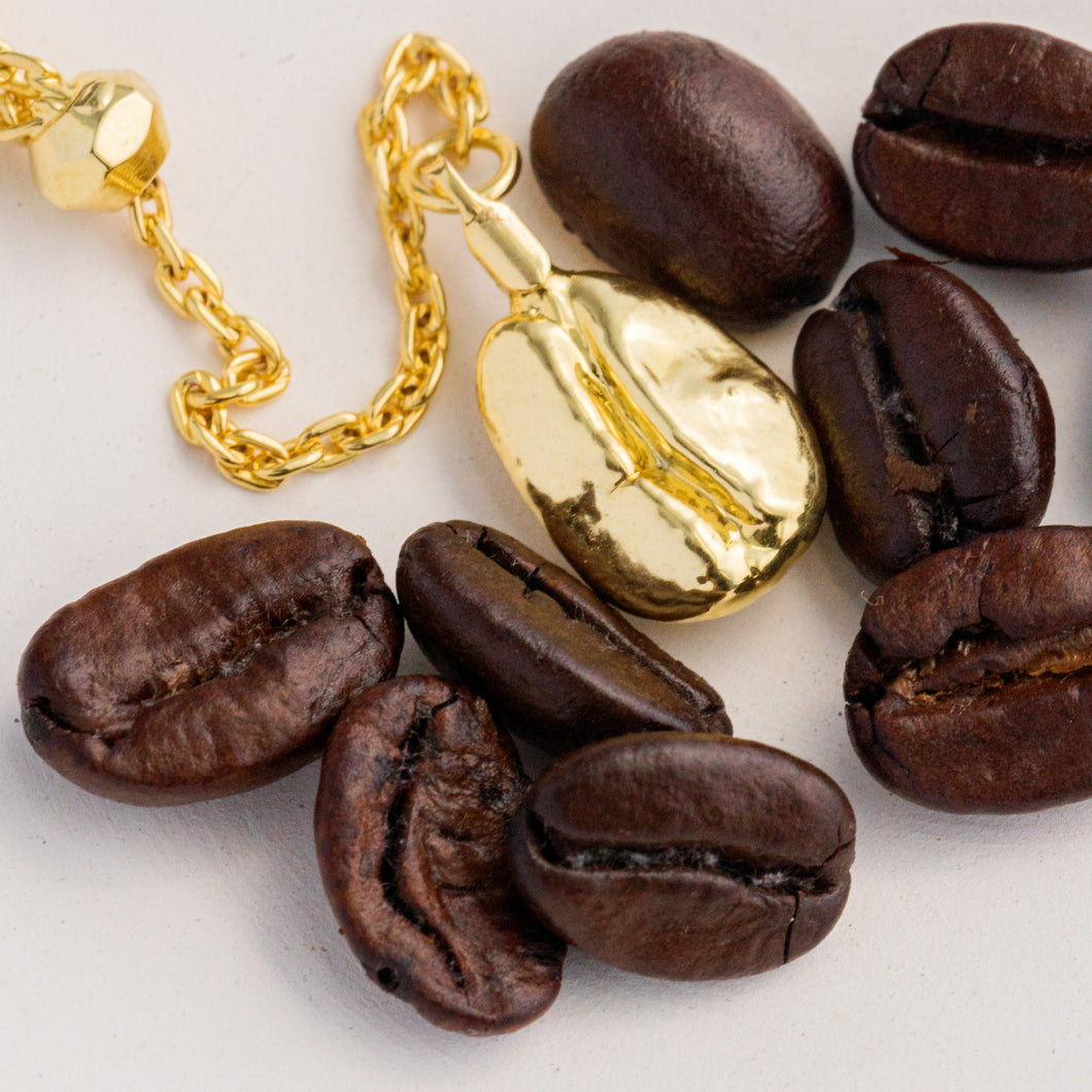 Close up of Gold Coffee Bean Necklace by CARLA SHAW